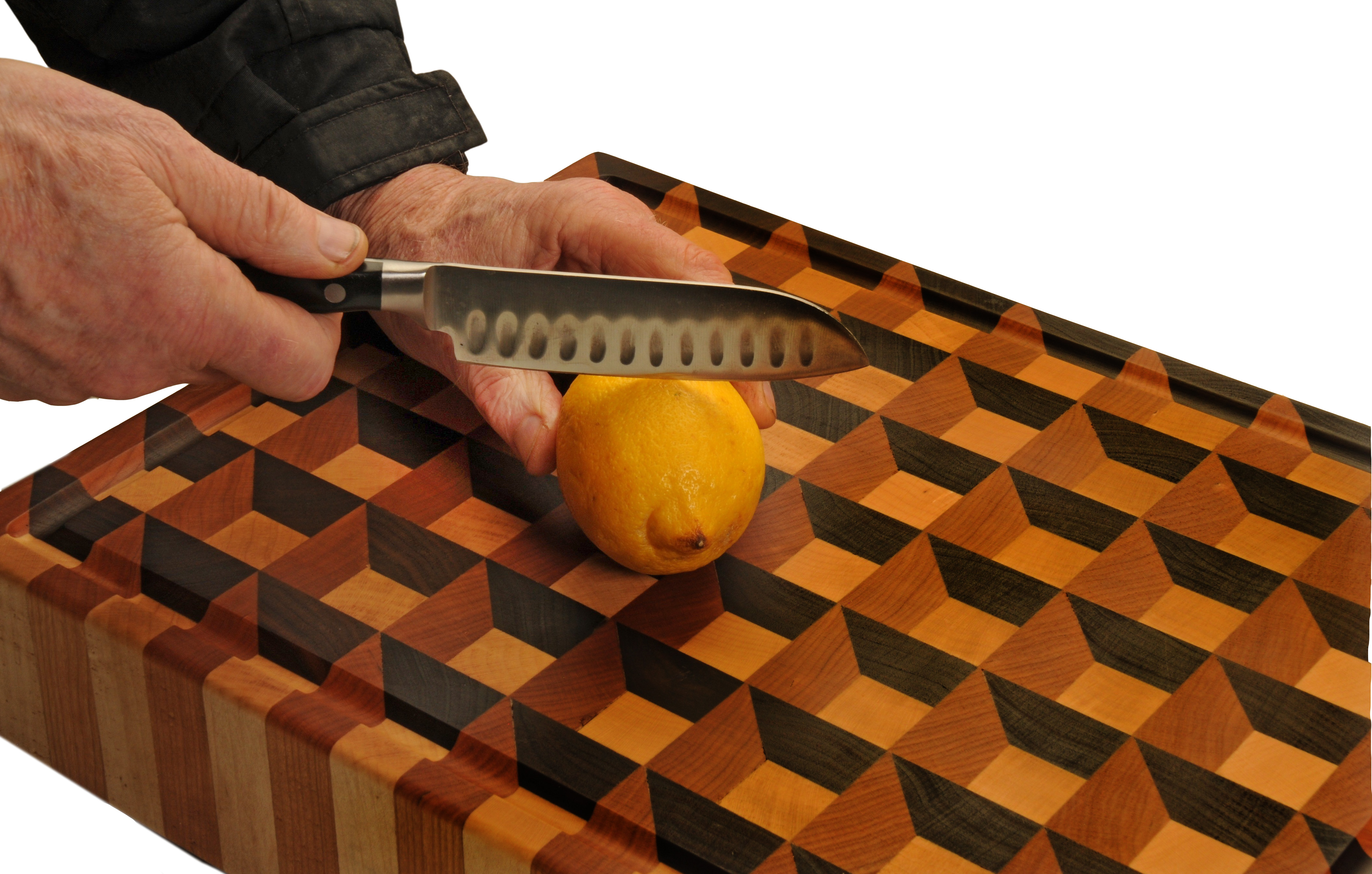Endgrain cutting block in use — a Santoku knife paring a lemon